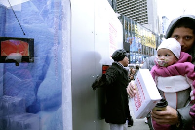 Staffers clad in silver body suits ushered the throng of guests from the heat scanning station to the vending machine and off the crowded traffic island.