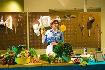 A Julia Child impersonator served mini croques monsieurs and coq au vin platters near the kitchen exhibit donated by the chef.