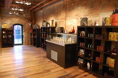 A selection of gourmet oils and fruit-infused maple syrups are displayed at the front of the boutique.