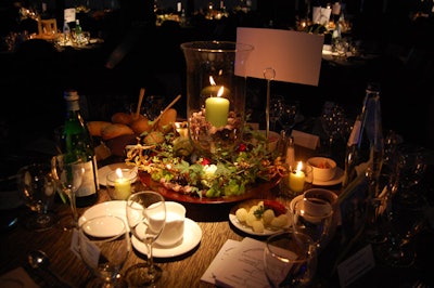 Decor & More topped tables with a variety of centrepieces incorporating candles, pine cones, and greenery.