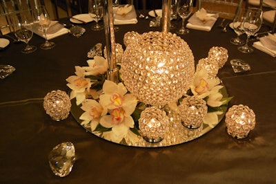Orchids surrounded crystal candleholders on tables at Tiffany & Company.
