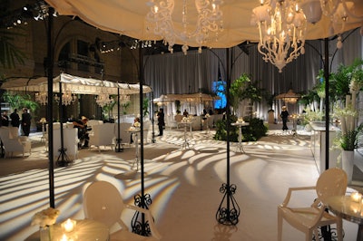 White carpet, sheer white fabric, gazebos covered with white canopies, and palms filled the cocktail space.