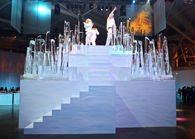 Models dressed in parkas posed on a large ice sculpture during the cocktail reception.