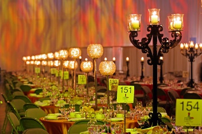 Black candelabras and beaded crystal candleholders topped tables.