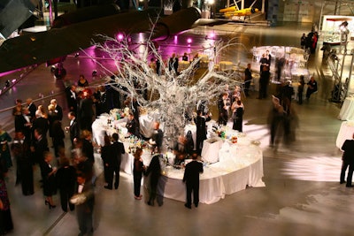 A theatrical silver-and-white frosted tree, draped with garlands of tiny mirrors, was fabricated on site.