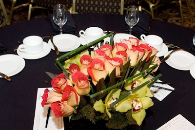 A floral centerpiece featured shoots of bamboo and added a pop of color to the event's earth-toned look.