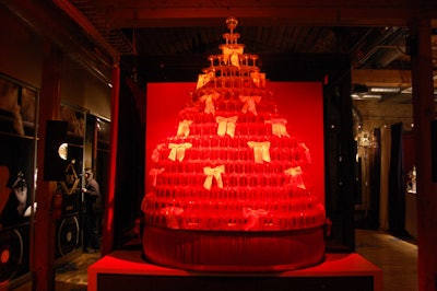 A tower of champagne glasses formed a Christmas tree at the entrance to the holiday party.