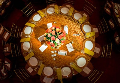 A gold and terra cotta color scheme topped the tables, accented by tall Murano glassware.