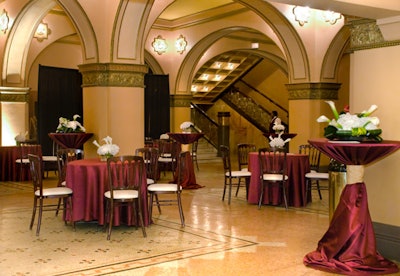 The evening began with an hour-long cocktail reception in the theater's lobby, where tables bore burgundy linens and white floral arrangements.