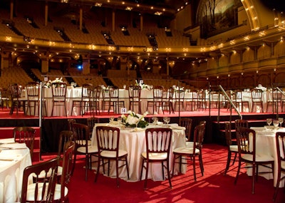To create a roomy dinner space, Event Architects built the Auditorium Theatre's stage out over the venue's first level of seating.