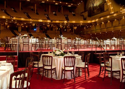 To create a roomy dinner space, Event Architects built the Auditorium Theatre's stage out over the venue's first level of seating.