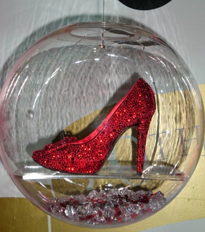The shoes were displayed in individual fishbowls lined with faux diamonds and rubies and suspended from the ceiling at varying heights along two walls.