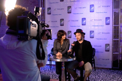 ETalk filmed interviews with members of Stars in front of a media wall bearing the Telus logo.