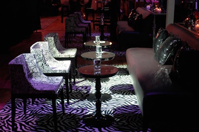 Philippe Starck's black and white Mademoiselle Missoni chairs from Contemporary Furniture Rentals provided seating for guests.