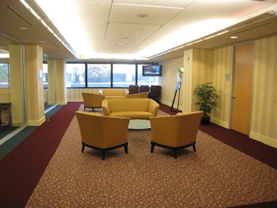 The Executive Conference Center offers side lounges with yellow leather couches for meeting breaks.