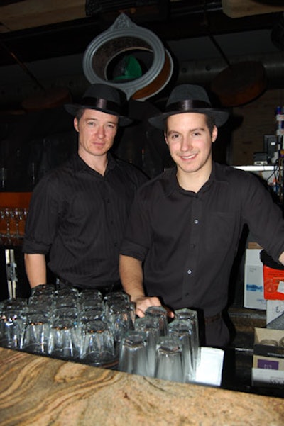 Servers in black fedoras offered drinks to guests.