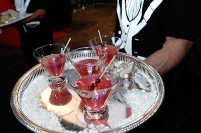 The Martini Club created Tinseltown Martinis with house-made vanilla- and cinnamon-infused vodka shaken with crushed wild berries and white cranberry juice, rimmed with red sugar, and garnished with frozen cranberries dusted in silver leaf.