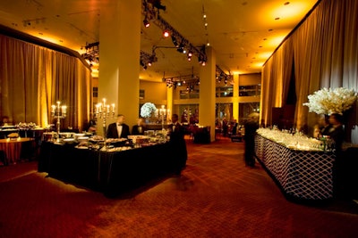 Inside the atrium, buffet tables held lavish spreads from Great Performances and some visual elements like candelabras and gray velvet drapes hinted at the World War II motif.