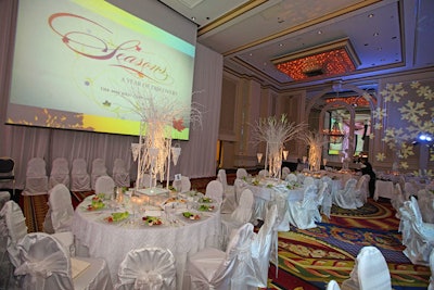 Ronsley Special Events adorned each dinner table with mulberry-branch centerpieces that sprung from mirror boxes filled with white hydrangea blossoms.