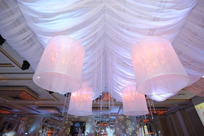 Over the dance floor, Ronsley Special Events suspended five crystal chandeliers from billowing sheets of translucent fabric.