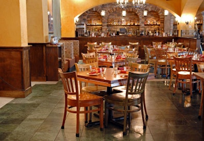 Zapatista's rustic interior features iron chandeliers and a bar backed with stone arches.