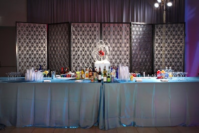 A screen backed a bar, topped with a cloth of sea-inspired blue.