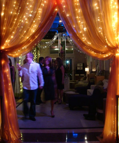 Adding intimacy to the space, Feldman draped sheer fabric interwoven with lights from the covered portion of the venue's roof deck.