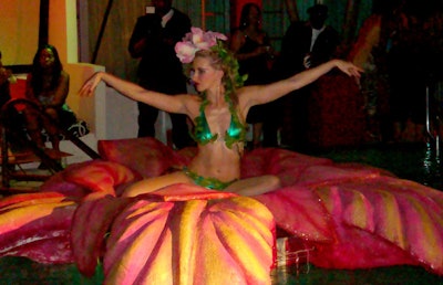 A model posed on a large floating orchid from Parafernalia Productions throughout the evening.