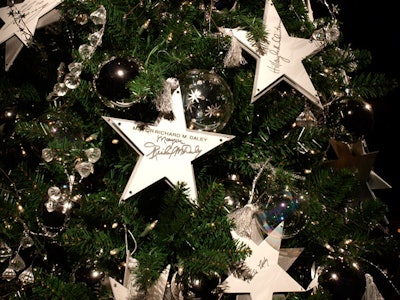 The 'Celebrity Tree,' adorned with notable autographs, sold for $5,000.