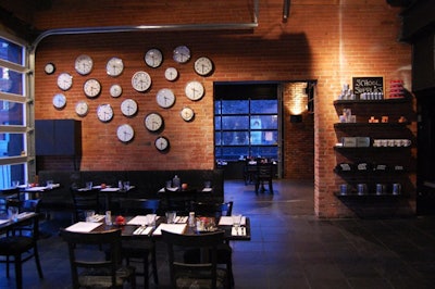 The wall dividing the two rooms features a series of clocks, all of which are set at 3:30 p.m. to mark the beginning of detention and the time when cocktails will be served.