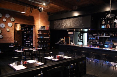 School supplies like T-shirts and coffee mugs fill shelves on the wall beside the counter, which doubles as a bar during private events.