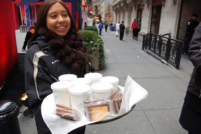 A Delta flight attendant passed out hot cocoa and branded chocolate biscuits from the London booth.