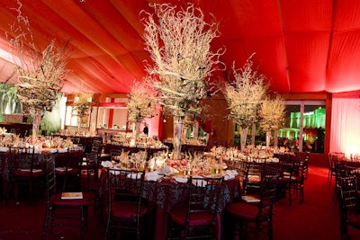 Barton G. topped each table at the Jackson Memorial Foundation's annual Golden Angels Gala with a tall centerpiece of dark burgundy mini calla lilies and curly willow that resembled the fateful cyclone in The Wizard of Oz-the gala's theme-surrounded by ruby red apples at each pedestal's base.