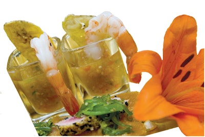 A chilled Cuban-inspired shrimp gazpacho shooter served with a plantain chip from Catering by Design in Tampa.