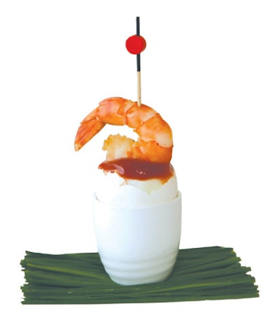 Eggwhites Special Event Catering in Miami serves its shrimp cocktail in an eggshell with aioli cocktail sauce in the hollow of the egg.