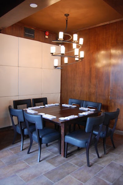 A table for eight sits in a small nook at the rear of the restaurant, beside the open kitchen.