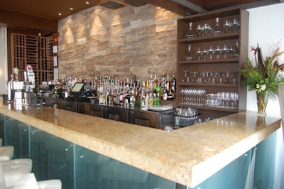 An Ontario tiger-striped limestone wall serves as a backdrop for the granite-topped bar.