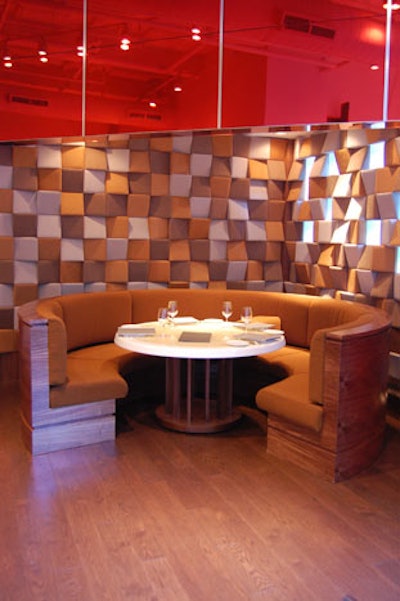 The wall surrounding a circular booth is reminiscent of the acoustic panels used in a recording studio.