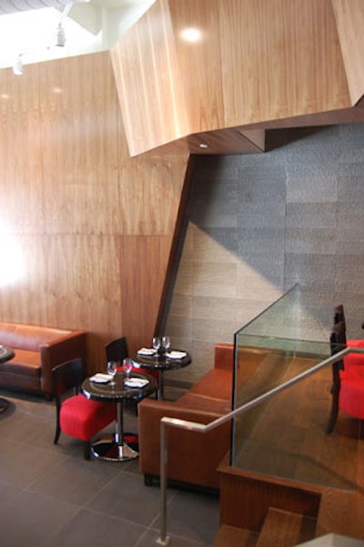 The lounge—accessed off of York Street—features polished black tables, red chairs, and tan leather sofas.
