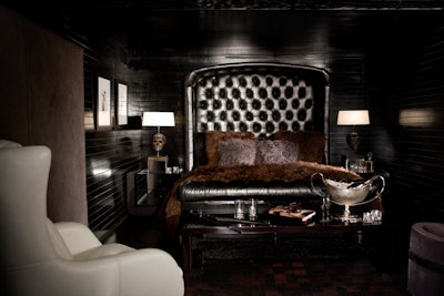 Dark hues and leather dress a bedroom.