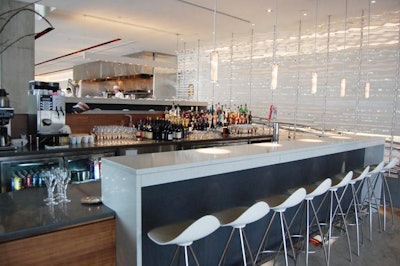 An acrylic wall designed by Mark Littlejohn provides a dramatic backdrop for the bar.