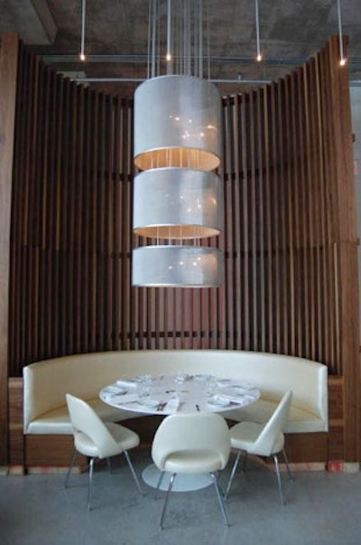 A curved booth located at the far end of the dining room is a focal point in the space.
