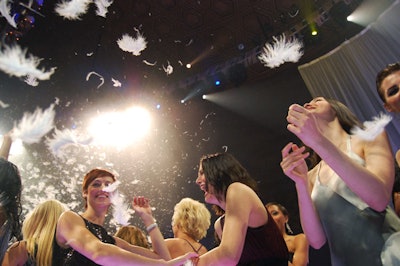 At the conclusion of the runway show, two feather cannons covered the crowd and catwalk with white feathers.