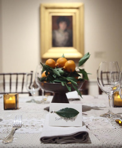 The organic theme extended to copper bowls of tangerines and place cards with fresh bay leaves.