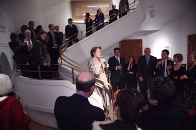 Alice Waters gave remarks at the foot of the grand staircase, which leads to the site of the dinner in the museum's original building,