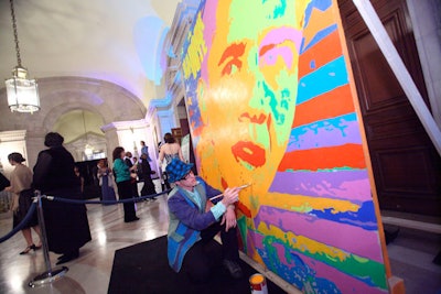 Ryan Paul Simon applied finishing touches to his Obama Mural at the party.
