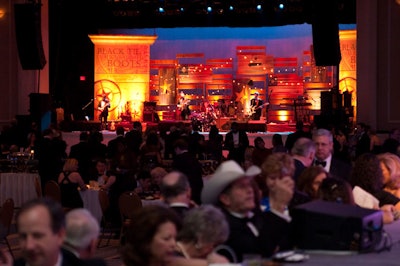 Approximately 4,000 people gathered in the Potomac Ballroom, which had been given a serious Western theme—the stage had wooden crates, wooden columns, vibrant colors, and American flags, all done by Show Call Productions.