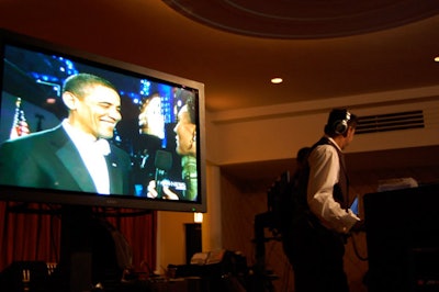 Footage from the Washington balls played on an oversize screen at the Parkway Ballroom.