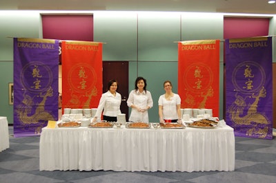 Colourful banners provided a backdrop for a food station where volunteers served suckling pig.