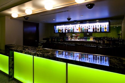 Bright green lighting illuminates a bar at the Show at Agua Caliente.